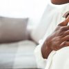 Photo of woman clutching her chest. (Photo by Getty Images)