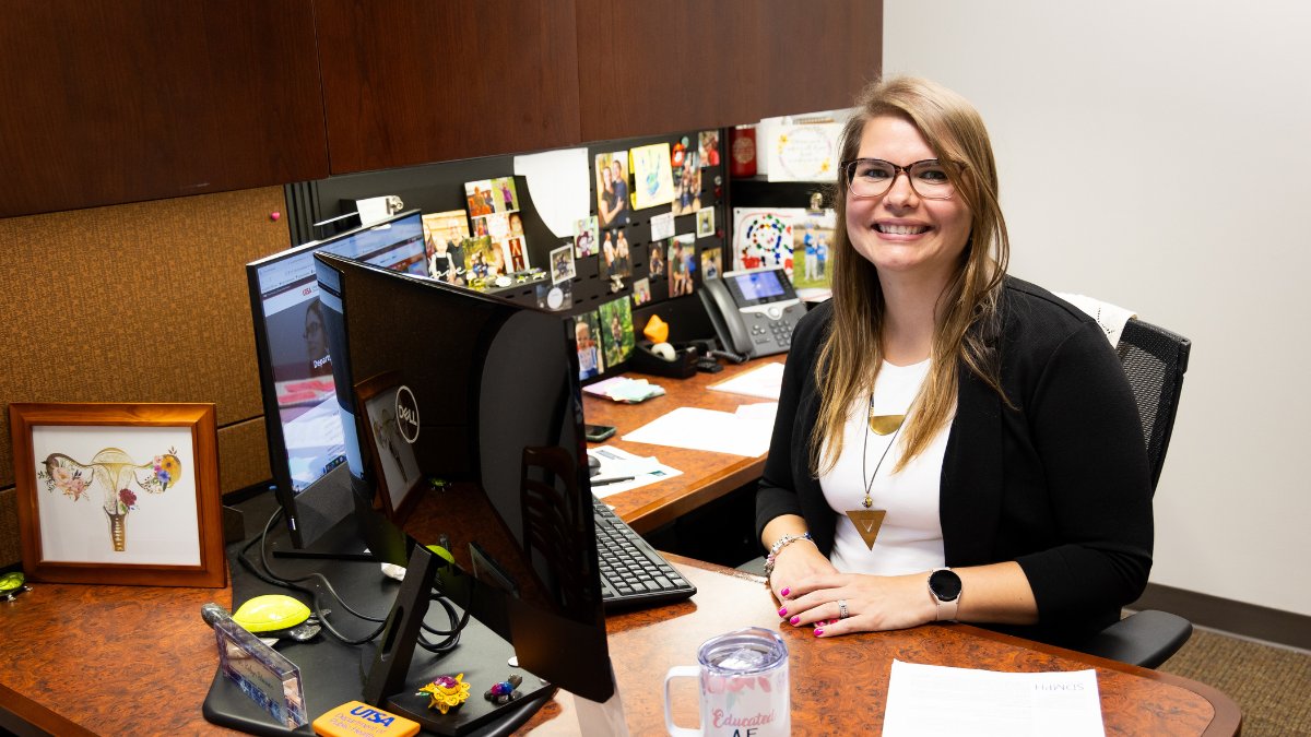 Robyn Stassen pictured at her computer desk surrounded by journals.