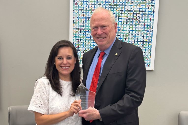 Belinda Hernandez, PhD, receives the R. Balmer Beasley Award from Eric Boerwinkle, PhD, dean of UTHealth Houston School of Public Health.