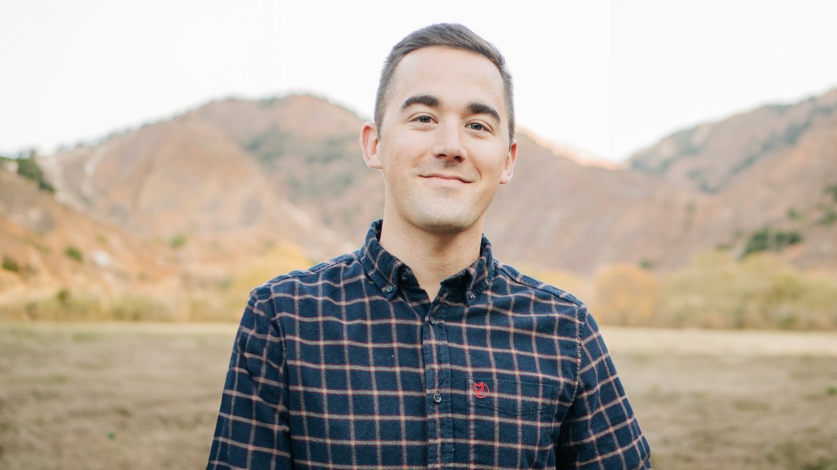 Christopher Pfledderer in front of mountains.