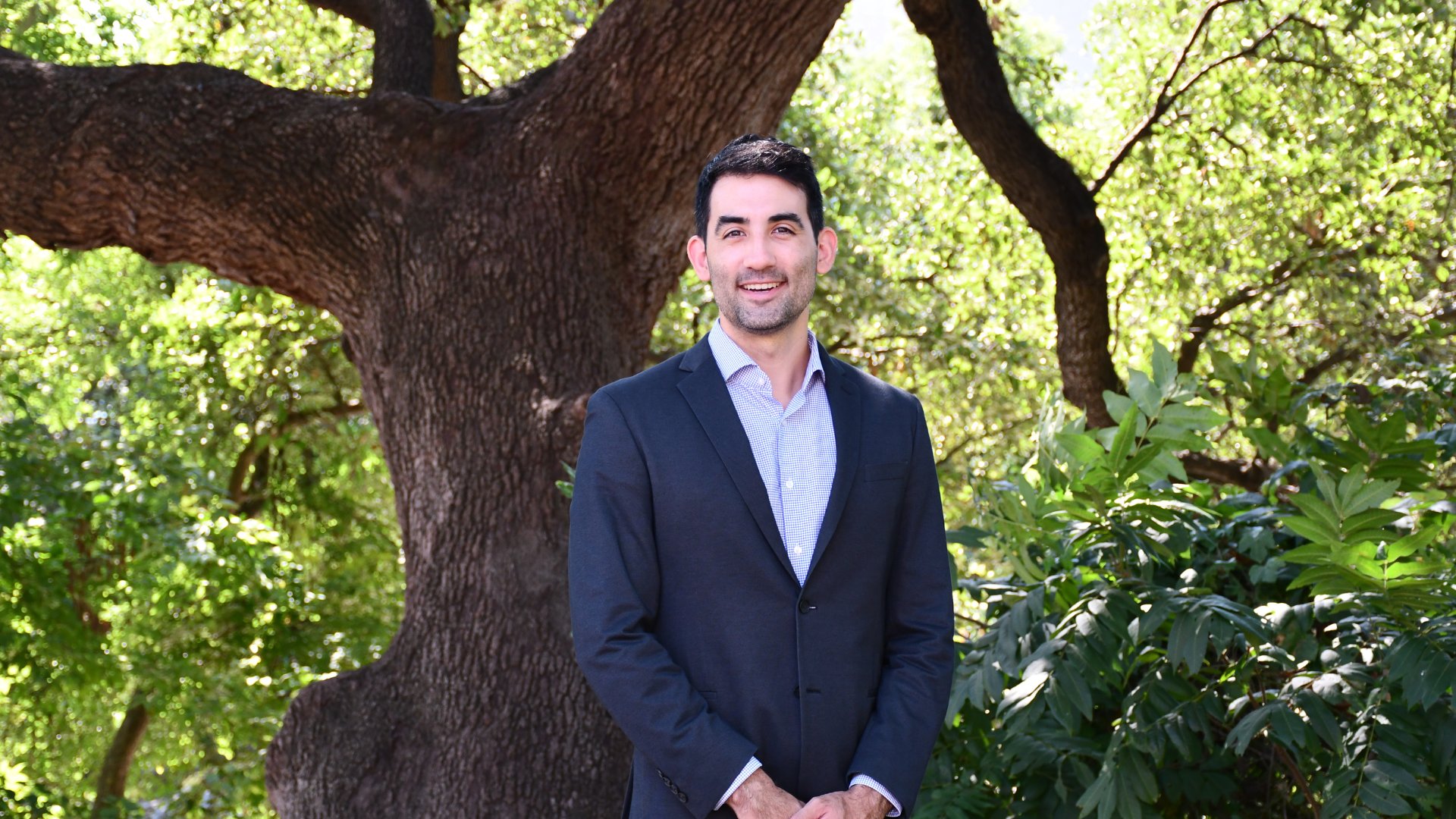 Kevin Lanza, PhD, shown infront of a tree
