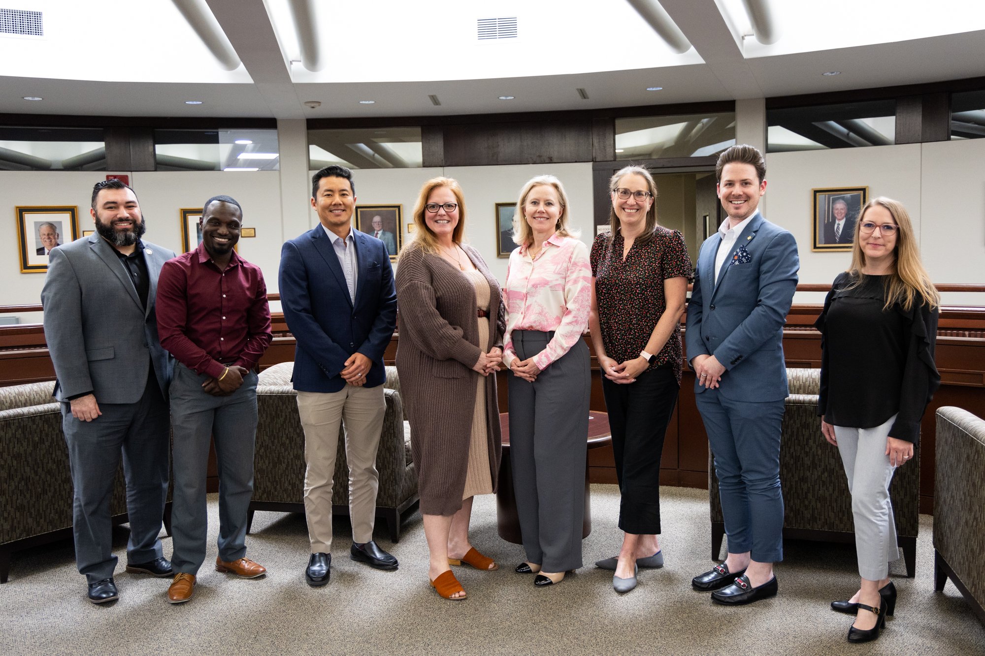 Staff members pictured in front of classroom.