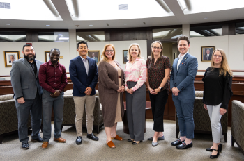Staff members pictured in front of classroom.