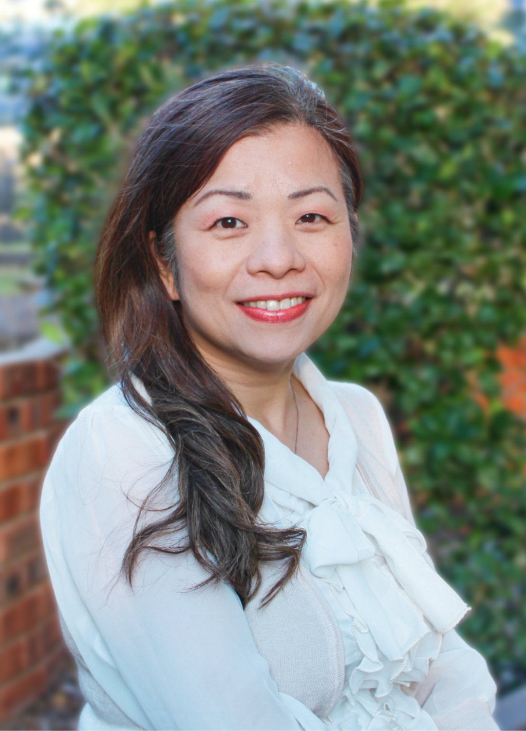 Ru-Jye (Lindi) Chuang, DrPH, MS, pictured in front of greenery.