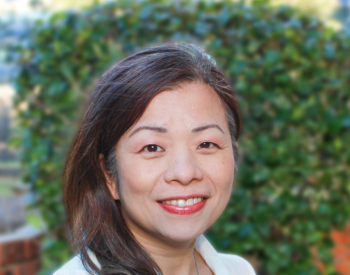 Ru-Jye (Lindi) Chuang, DrPH, MS, pictured in front of greenery.