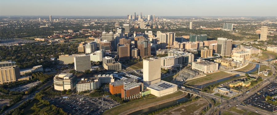 Aerial view of the Texas Medical Center in Houston with Downtown on the background