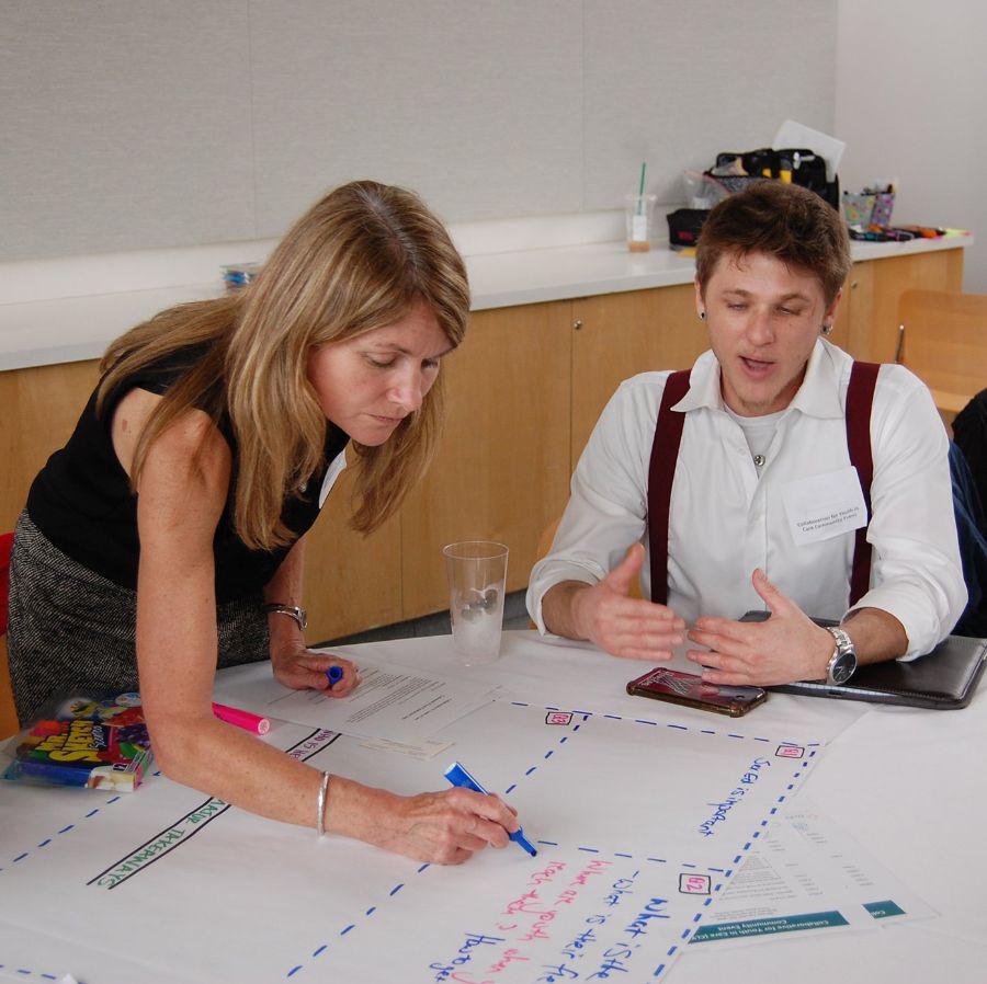 Dr. Markham works with community partner. Photo by Aaron Nieto.