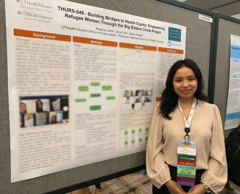 Meghna Lama in front of research poster.
