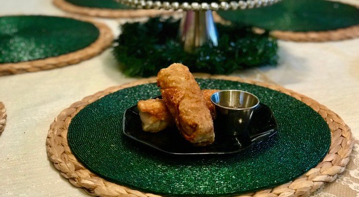 Egg Roll on Black Plate and green placemat