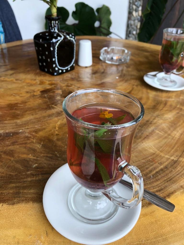 Brewing Aromatica on a clear cup on top of wooden table.