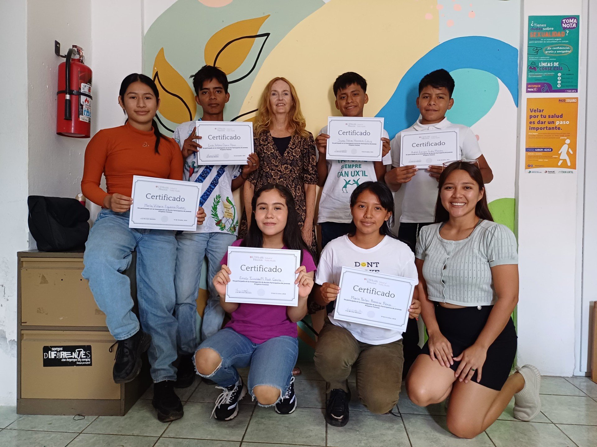 Lisa Mitchell Bennett (top middle) pictured with students at graduation.