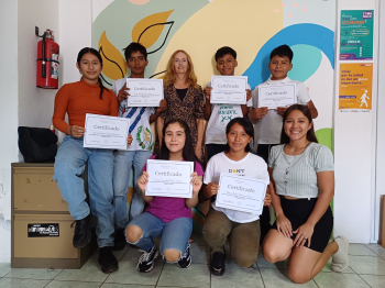 Lisa Mitchell Bennett (top middle) pictured with students at graduation.