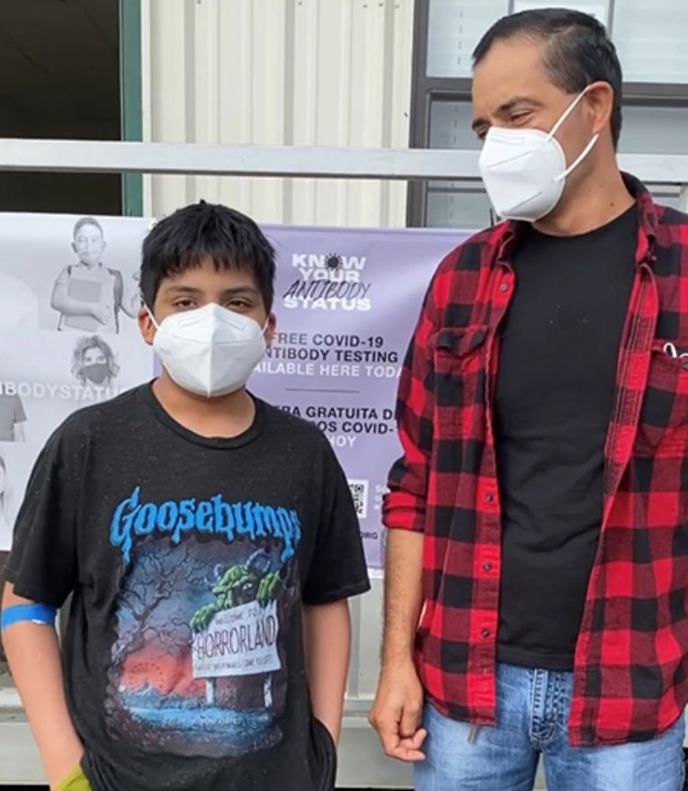 Photo of a father and son at a Texas CARES event.