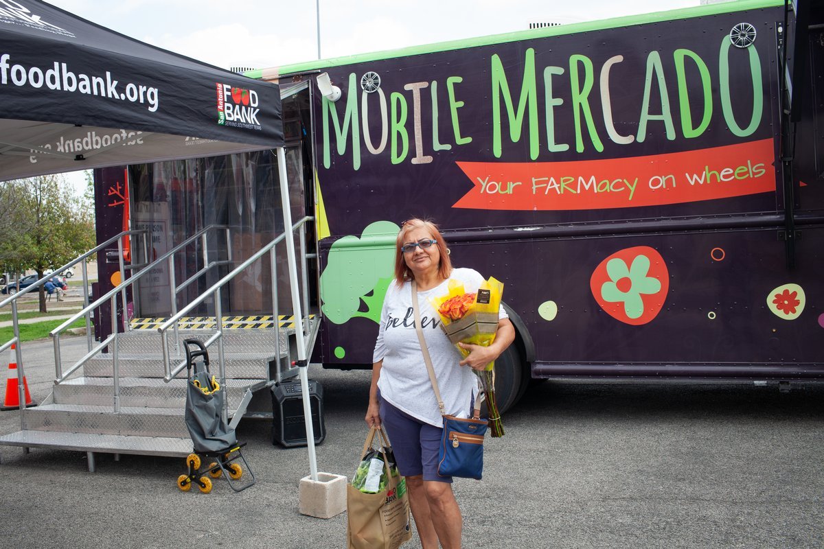 A Prospera resident with groceries from the San Antonio Food Bank Mobile Mercado.