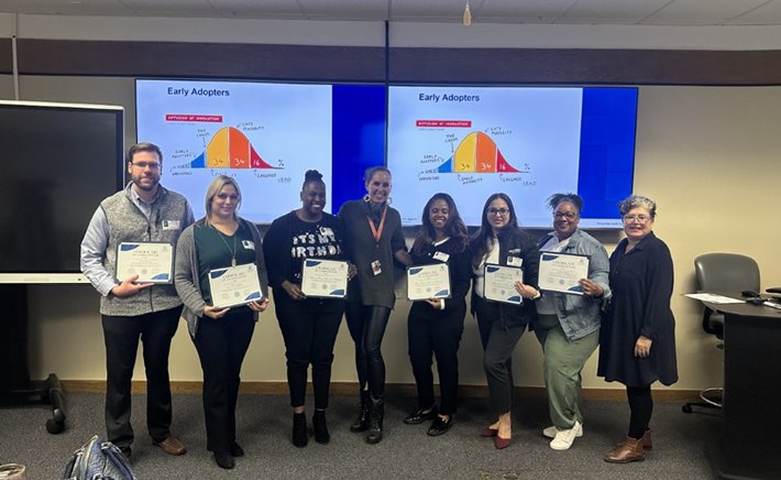 Center for Health Equity members holding up certificates
