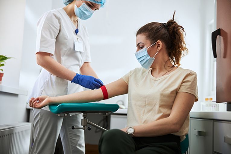 Photo of woman getting her blood drawn. (Photo by Getty Images)