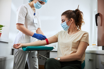 Photo of woman getting her blood drawn. (Photo by Getty Images)