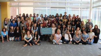 Group of students holding the Albert Schweitzer Fellowship sign posing for a photo.