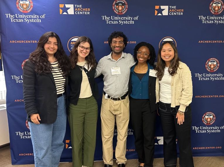 Archer fellows pictured in front of backdrop.