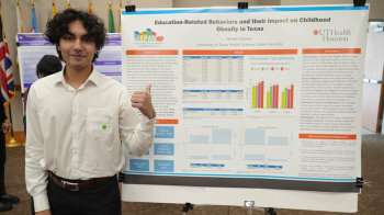 Arham Salman pictured in front of research poster.