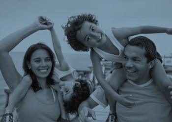 A mother and father hold their children on their shoulders