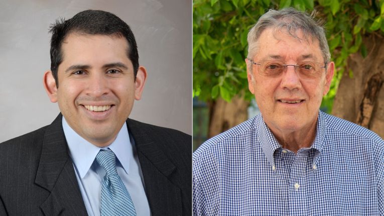 Doctors Absalon Gutierrez and Joseph McCormick posing side by side and smiling.