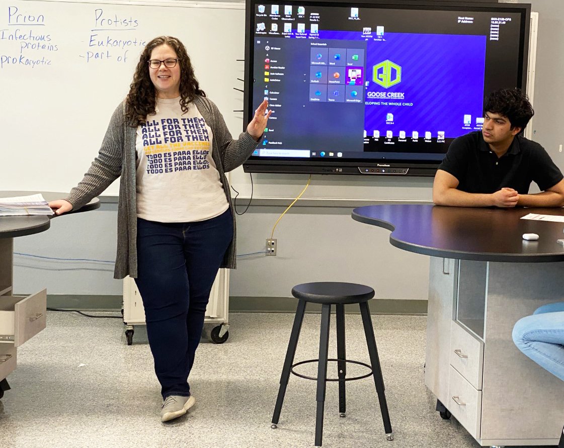 Ross S. Sterling High School senior Abdul Samad, right, listens as All for Them senior program manager Efrat Gabay, MPH talks to students about the clinic that would be held at the Goose Creek CISD campus.