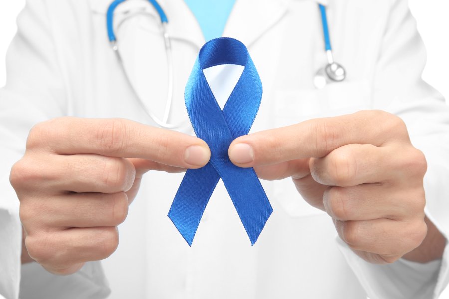 A doctor holding a blue colorectal cancer ribbon.