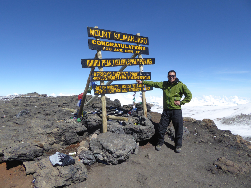 Jack Tsai, PhD, at the top of Mt. Kilimanjaro in Tanzania, the highest mountain on the continent of Africa.