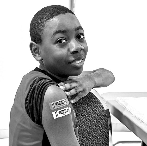 Kid with bandaids at the aldine community clinic