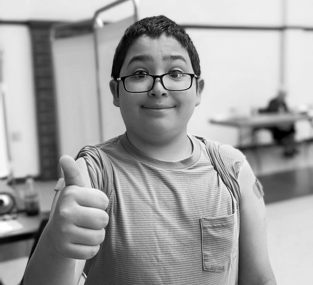 The boy gives a thumbs up