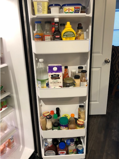 fridge door shelves with food unorganized