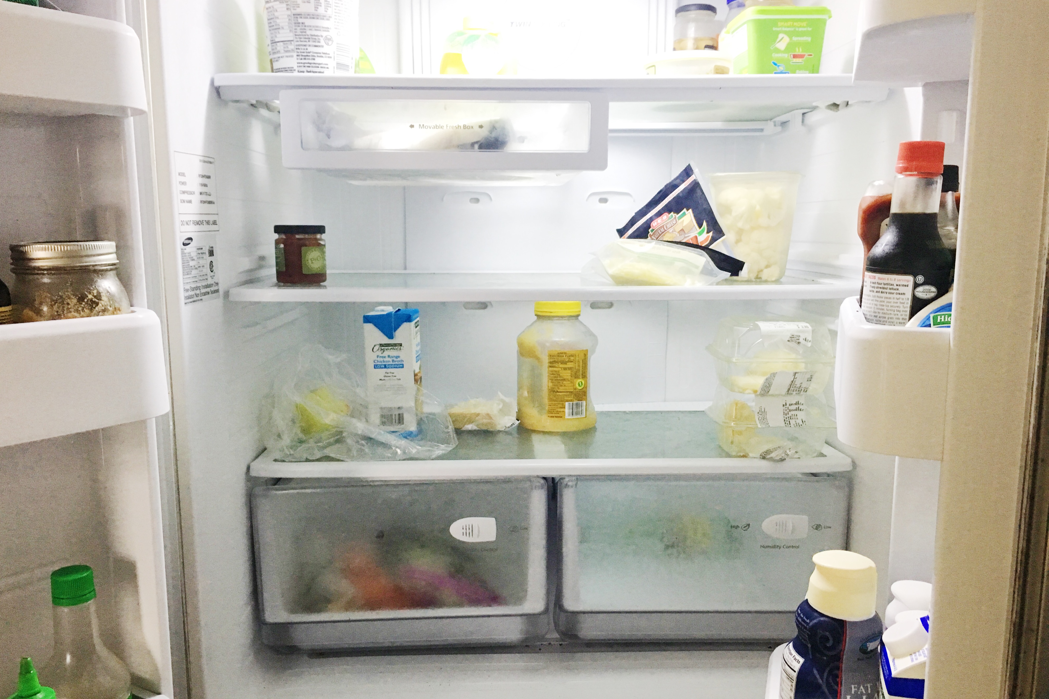 inside shelves of fridge with a few food items