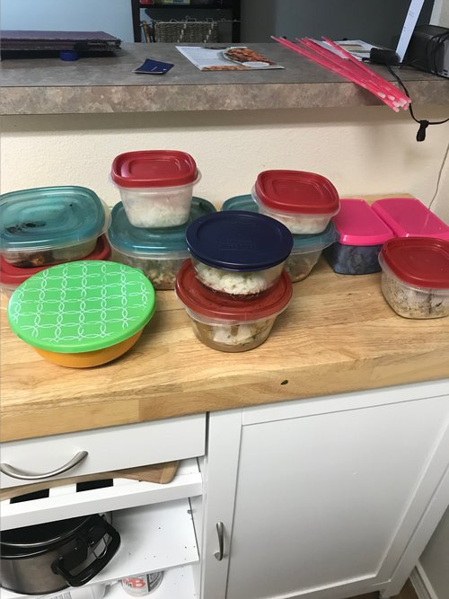 11 tupperwares full of prepared food