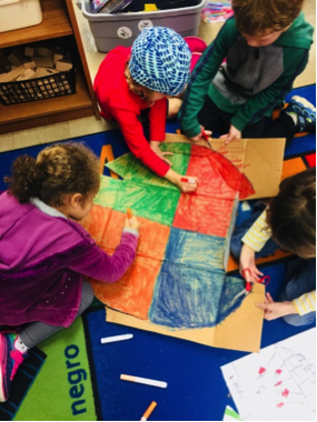 4 kids coloring a circle red, green, blue, and orange