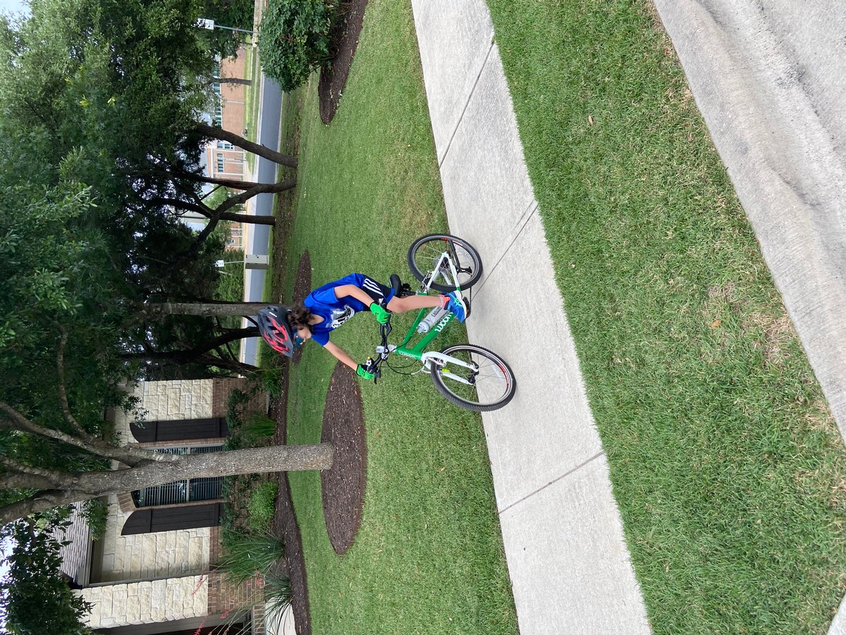 boy biking on sidewalk